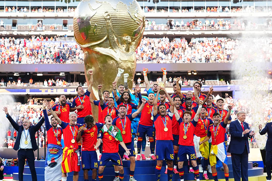 Rodri of Spain celebrates by lifting the FIFA World Cup trophy with teammates.